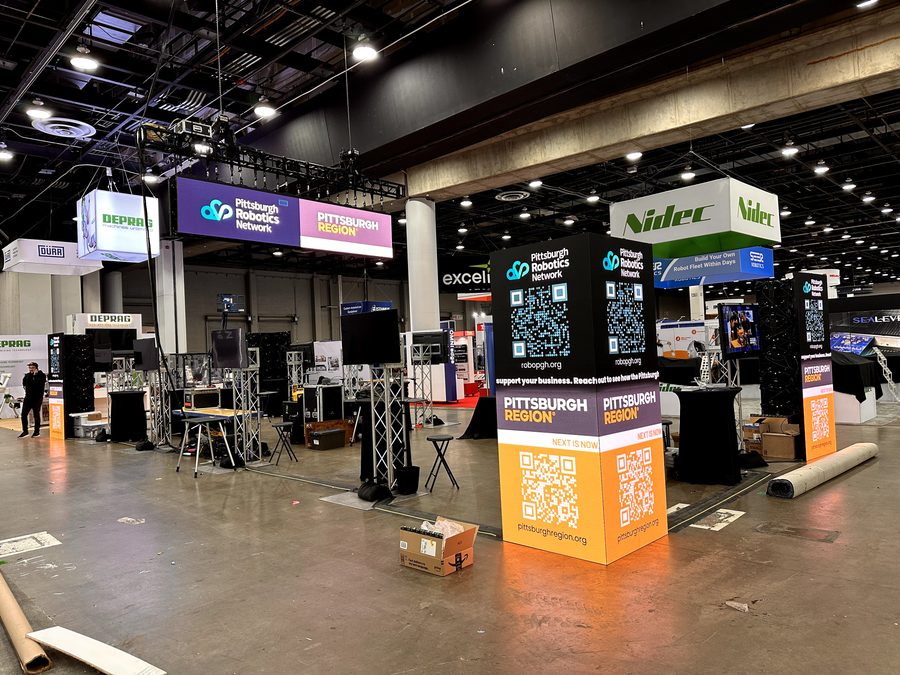 Wide view of the corner screens, overhead sign, and surrounding displays.