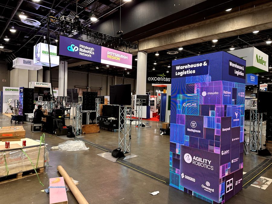 Warehouse and logistics graphics during booth setup.